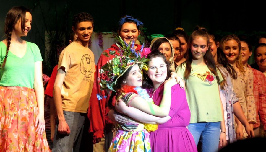 Lydia Orme (left) and Lauren Dougherty embrace on center stage in the Spring-Ford production “Once on this Island.” 