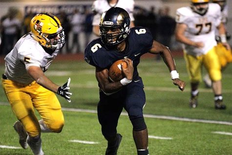 Junior running back Armante Huxta avoids a tackler during Spring-Fords 38-21 victory over Pope John Paul II on Oct. 25. The Rams won the Pioneer Athletic Conference championship with the victory. 