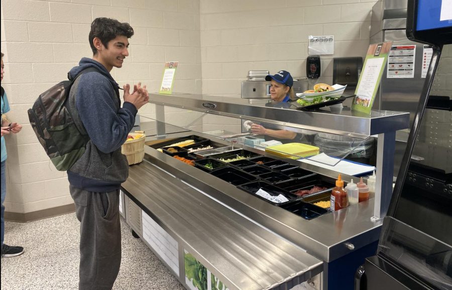 Junior Rafael Rodriguez prepares to order at the new deli station at the cafeteria. The station is one of several changes made by new operator Aramark.