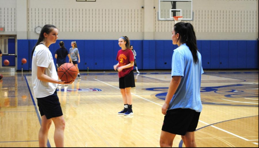 Junior Hailey Hudak speaks with senior teammate Alyssa Yuan during the first practice of girls basketball season Nov. 18. 