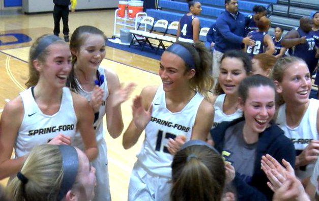 Spring-Ford basketball player Lucy Olsen (left) is greeted by teammates after scoring her 1,000th point in an 85-15 victory over Pottstown. 