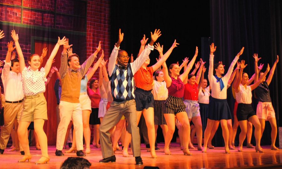 Actors perform a tap dance routine at the beginning of Spring-Fords musical 
