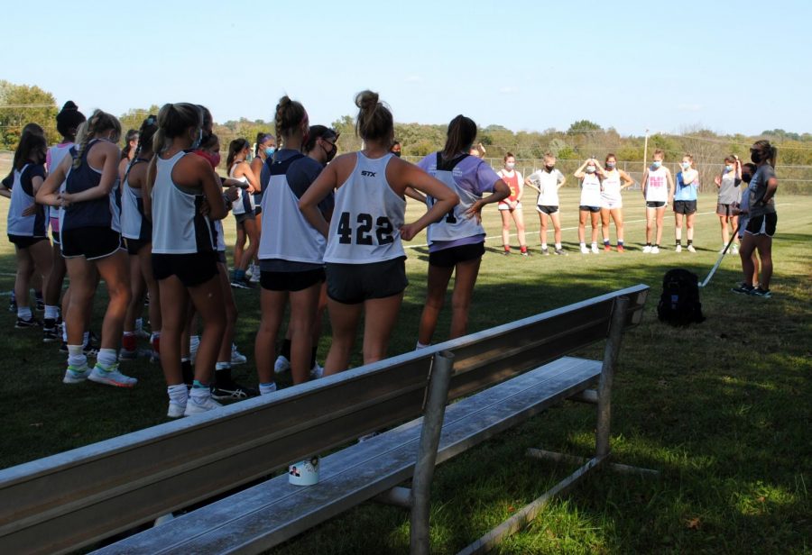 Coach Jennie Anderson (right) addresses the field hockey team Wednesday, Sept. 23.
