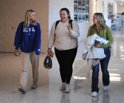 From left, Sammy Vickery, Amy Prophet, and Ally Frink walk down the art studio hallway in the 10-12 Center in March. 