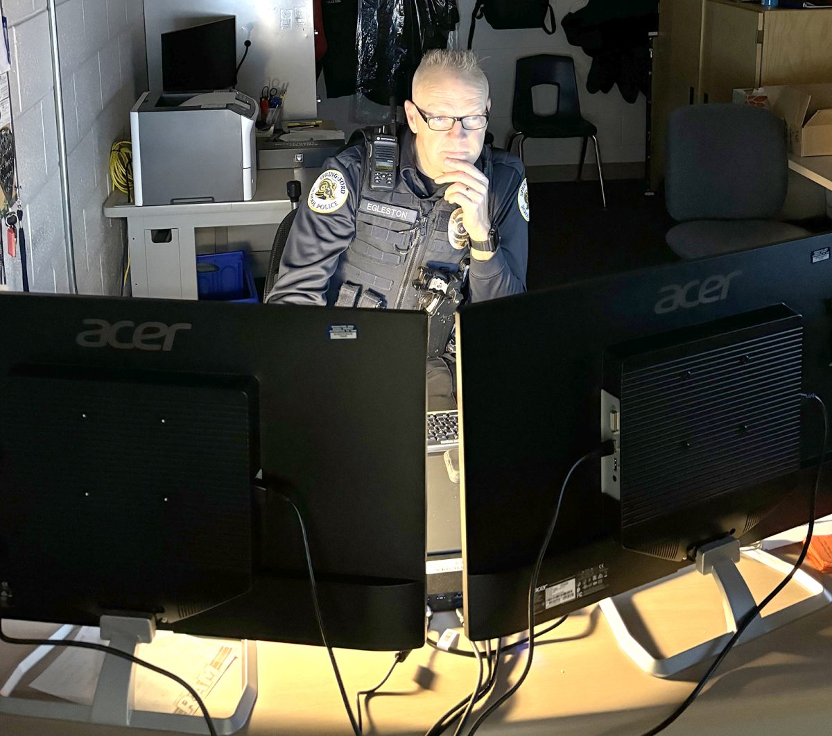 Officer David Egleston of the Spring-Ford Police Department monitors security cameras at the 10-12 Center.  Staff Photo
