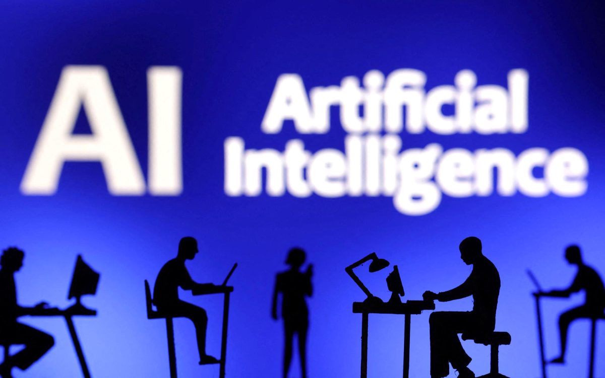 Figurines with computers and smartphones are seen in front of the words “Artificial Intelligence AI” in this illustration taken, Feb. 19, 2024. 

